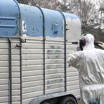 Blasting a horsebox trailer to remove the rust and paint.
