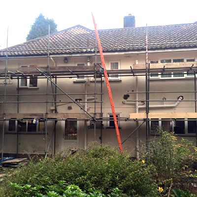 Paint removal from a house using scaffolding to work safely at height