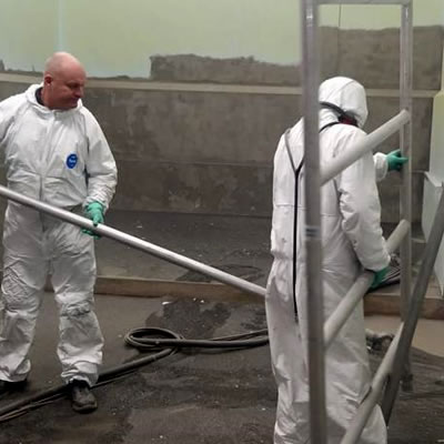 Symblast team blast cleaning the concrete walls