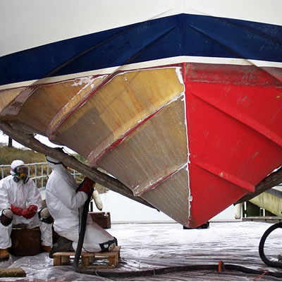 Workers applying the treatment to a hull.