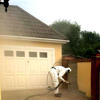 Blast cleaning a concrete rendered wall